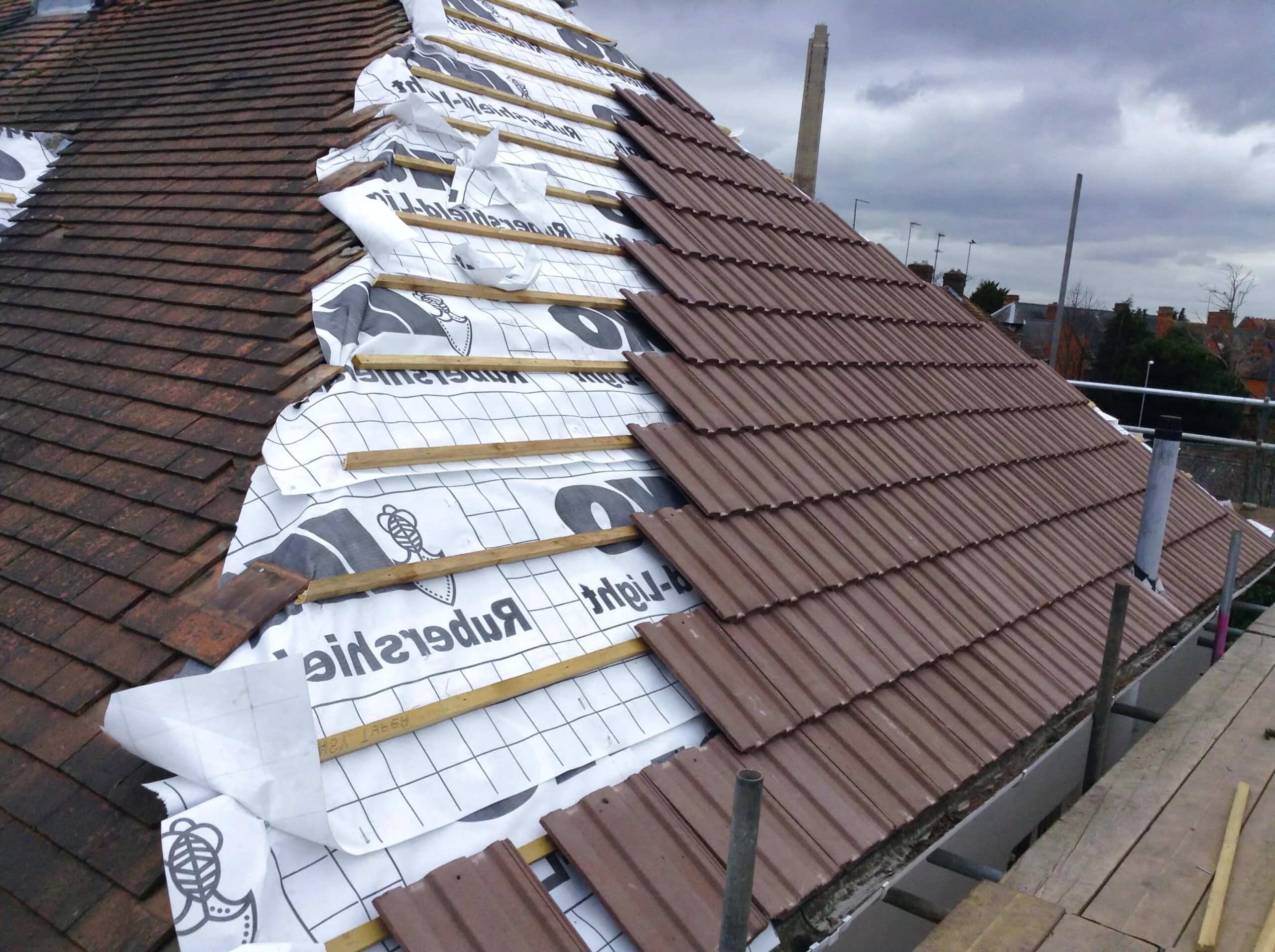 Close-up of overlapping roof tiles for comparing slate and concrete tile roofing